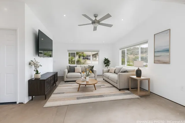 a bedroom with a bed wooden floor and windows