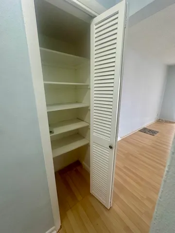 a view of bedroom with wooden floor