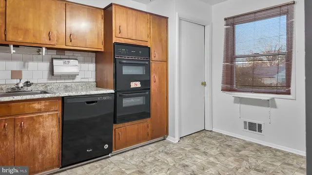 a view of a kitchen with granite countertop cabinets