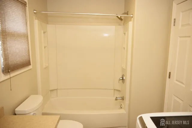 a bathroom with a shower and a toilet