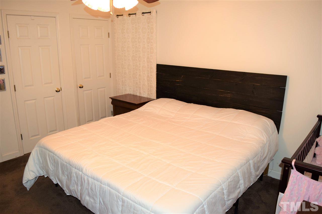 3917 Howard Circle Raleigh, NC 27604 - Photo 10 of 16 a large bed sitting in a bedroom next to a cabinet