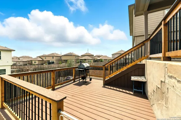 a view of balcony with wooden floor and fence