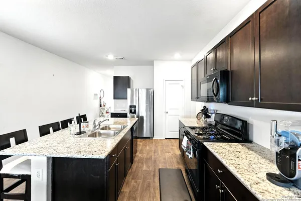 a kitchen with a stove and a refrigerator