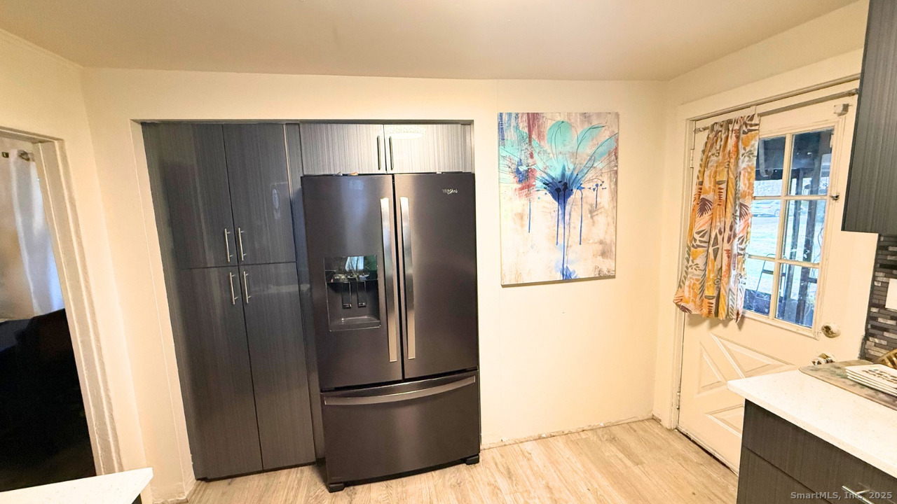 57 Austin Street New Haven, CT 06515 - Photo 3 of 18 a metallic refrigerator freezer sitting in a kitchen
