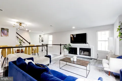 a living room with furniture fireplace and flat screen tv