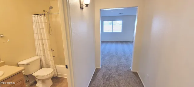 a bathroom with a toilet and a shower