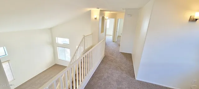 a view of a hallway with wooden floor and interior of house