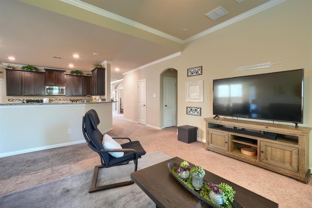 12417 Hitch Rack Way McKinney, TX 75071 - Photo 6 of 17 Carpeted living room featuring ornamental molding