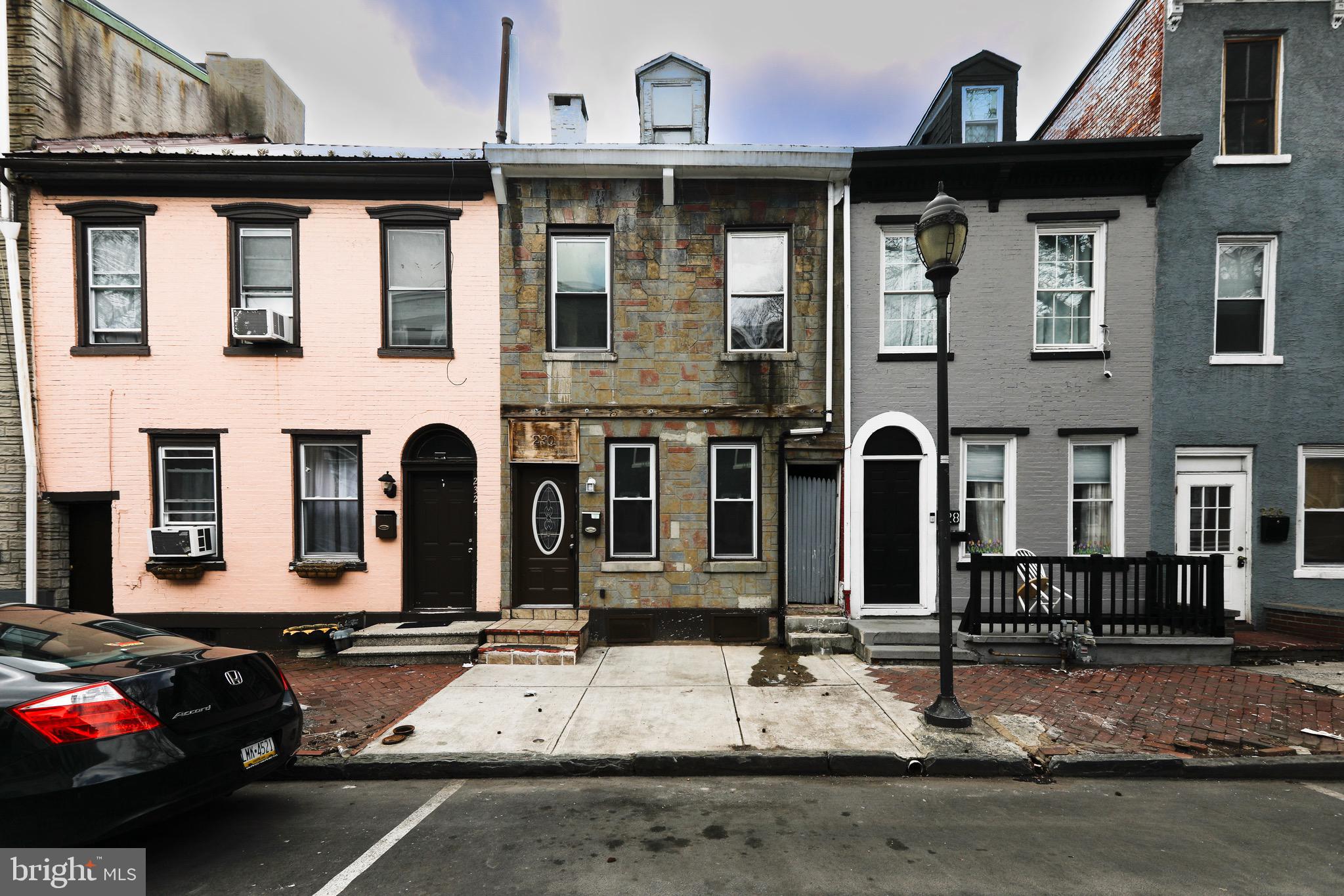 230 South 4th Street Reading, PA 19602 - Photo 1 of 26 a front view of a house with parking space