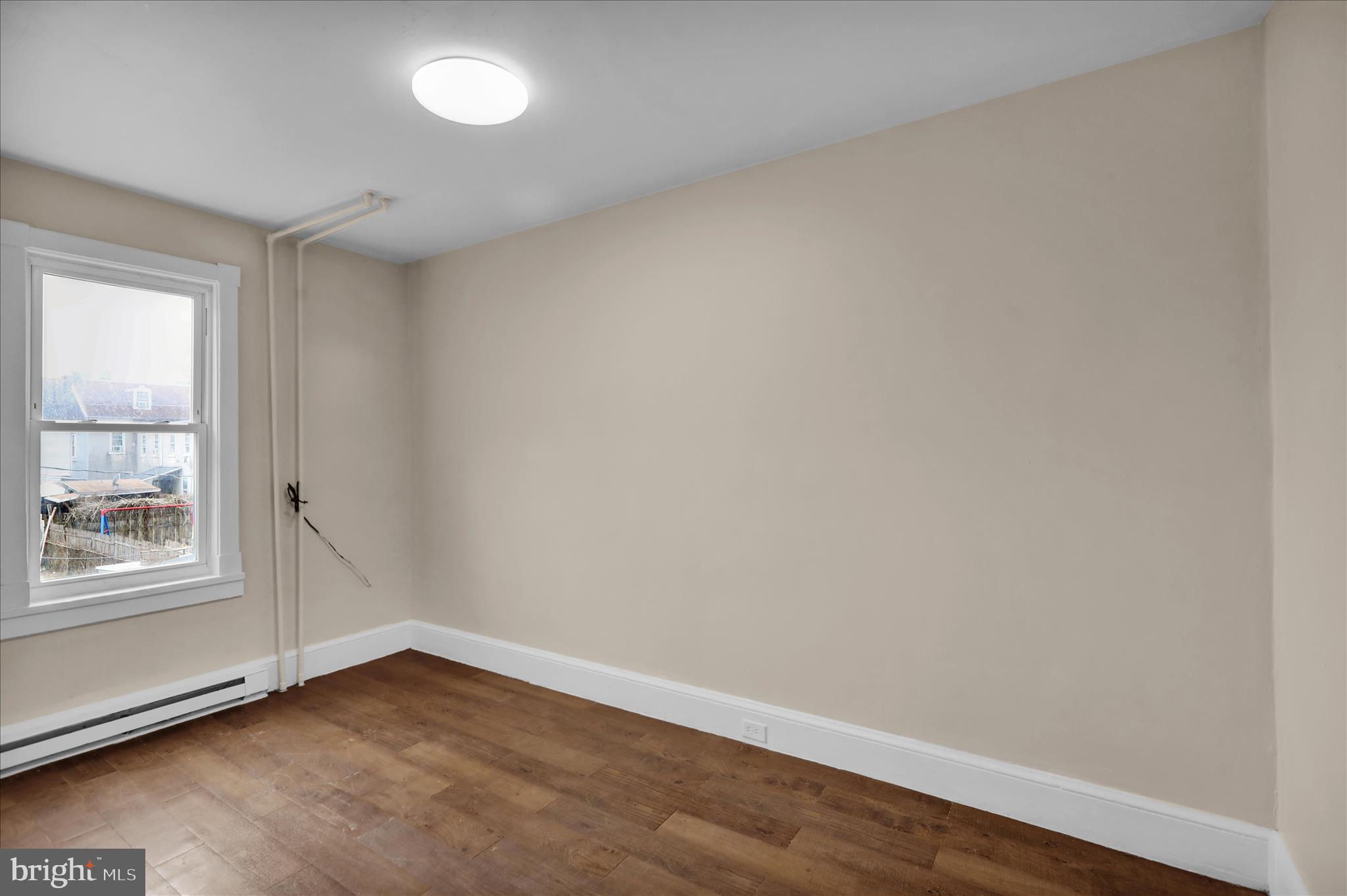 230 South 4th Street Reading, PA 19602 - Photo 14 of 26 an empty room with wooden floor and windows