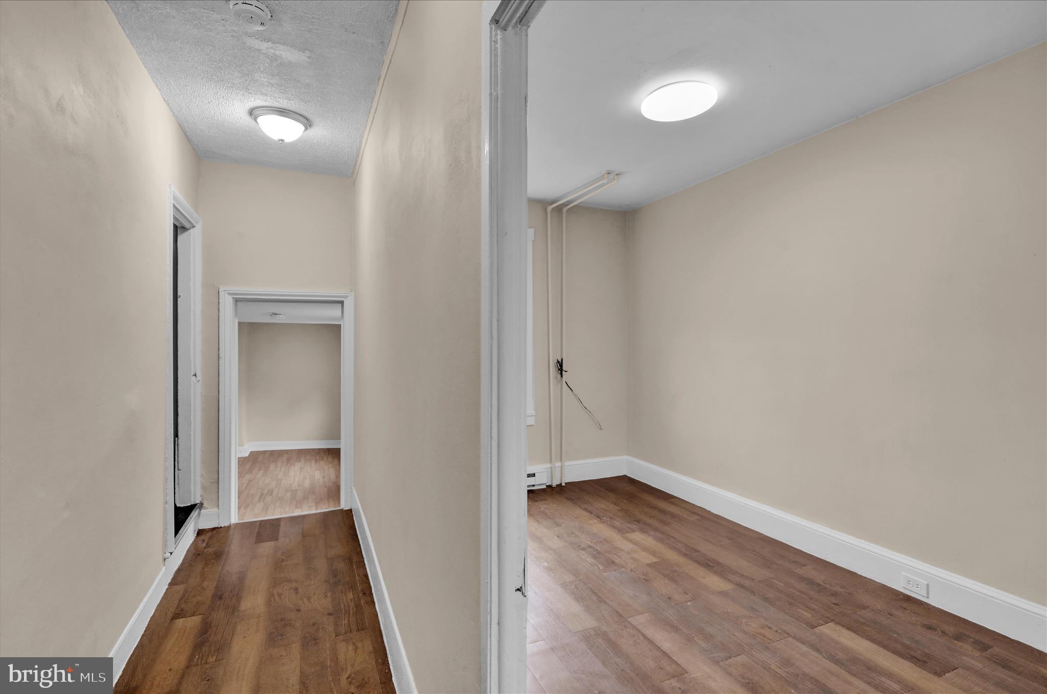230 South 4th Street Reading, PA 19602 - Photo 15 of 26 a view of a hallway with wooden floor