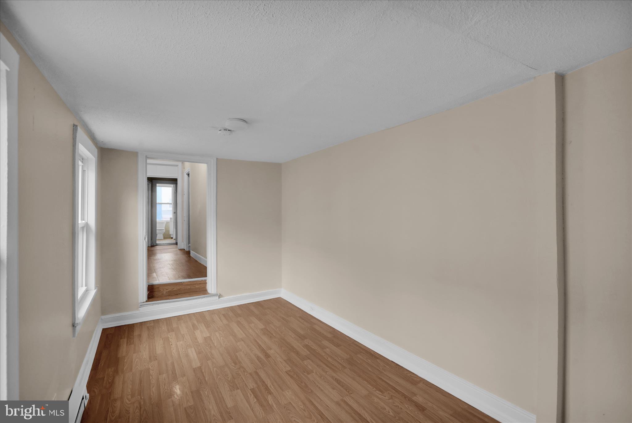 230 South 4th Street Reading, PA 19602 - Photo 17 of 26 a view of wooden floor and windows in a room