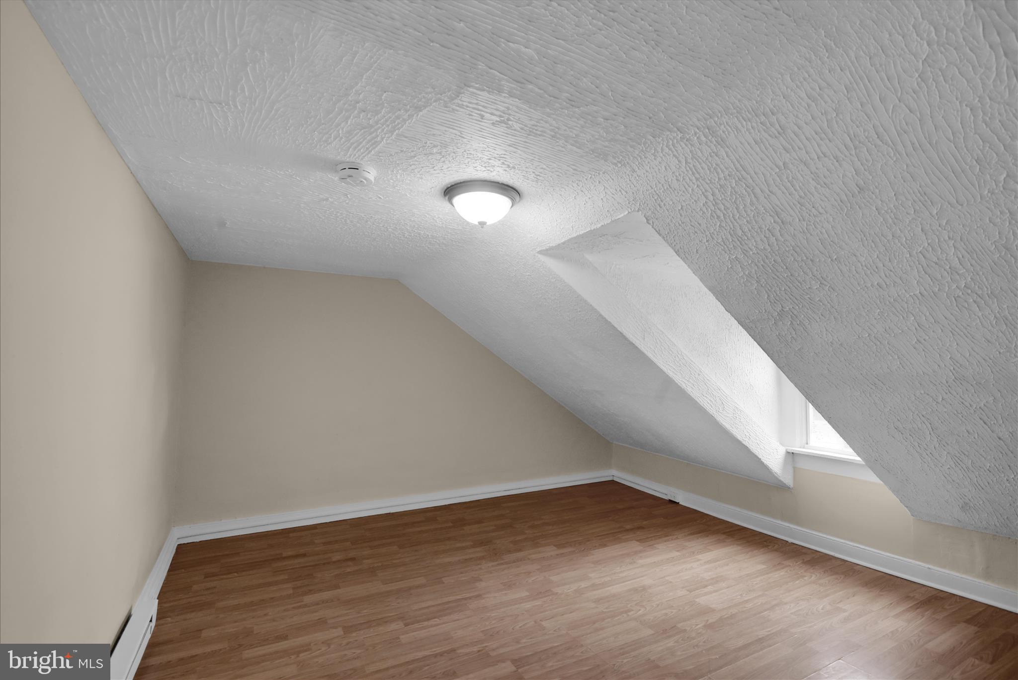 230 South 4th Street Reading, PA 19602 - Photo 18 of 26 a view of an empty room with wooden floor
