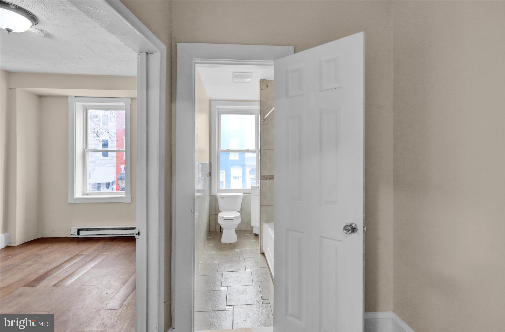 230 South 4th Street Reading, PA 19602 - Photo 9 of 26 a view of a room with wooden floor and windows