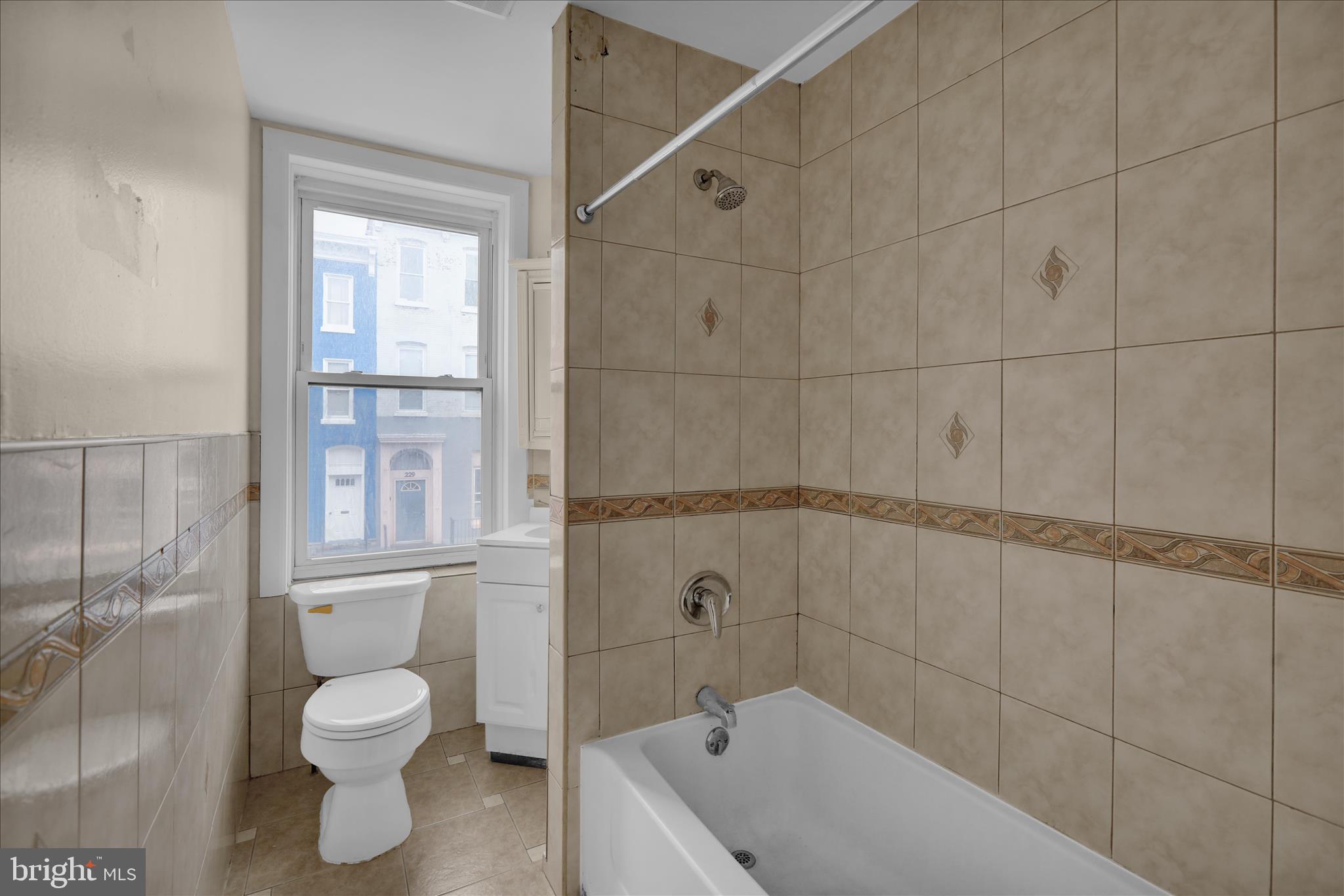 230 South 4th Street Reading, PA 19602 - Photo 10 of 26 a bathroom with a granite countertop bathtub shower and toilet