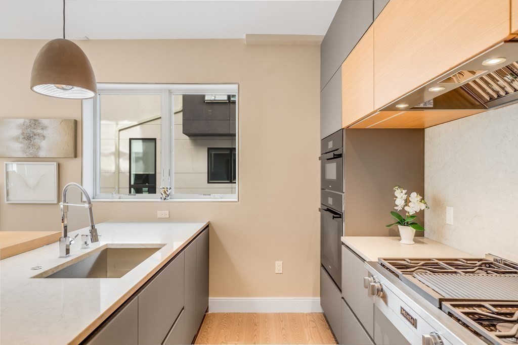 75 Westbourne Terrace, Unit 75 Brookline, MA 02446 - Photo 11 of 31 a kitchen with stainless steel appliances granite countertop a sink and a stove