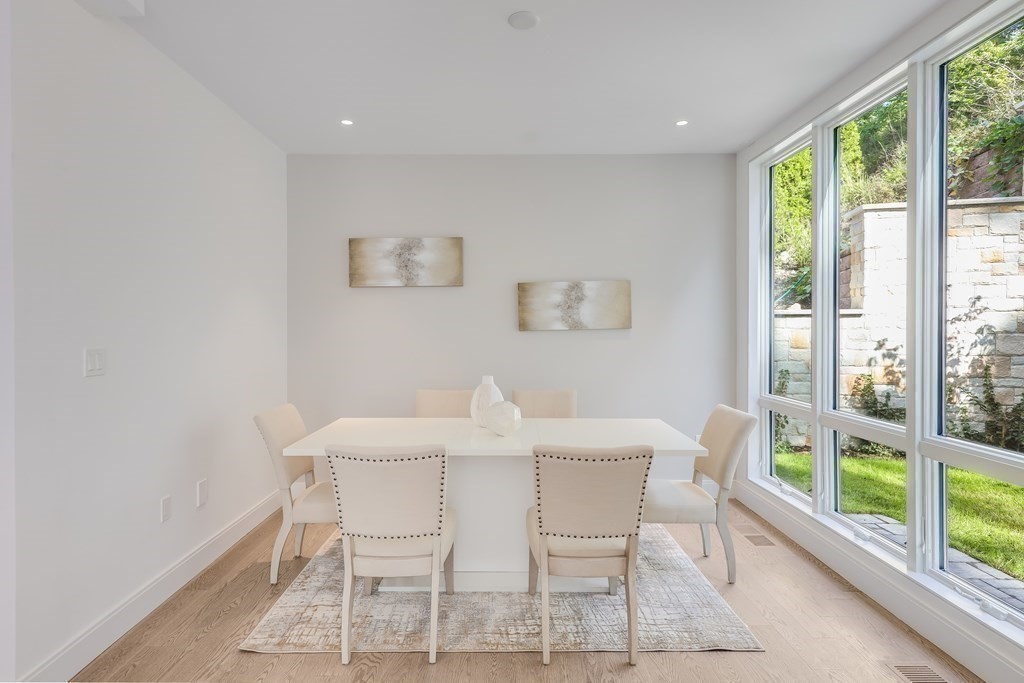 75 Westbourne Terrace, Unit 75 Brookline, MA 02446 - Photo 12 of 31 a view of a dining room with furniture large windows and wooden floor