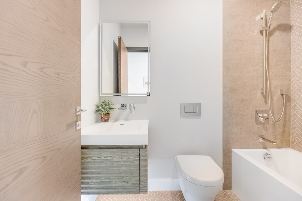 75 Westbourne Terrace, Unit 75 Brookline, MA 02446 - Photo 14 of 31 a bathroom with a sink a toilet and shower