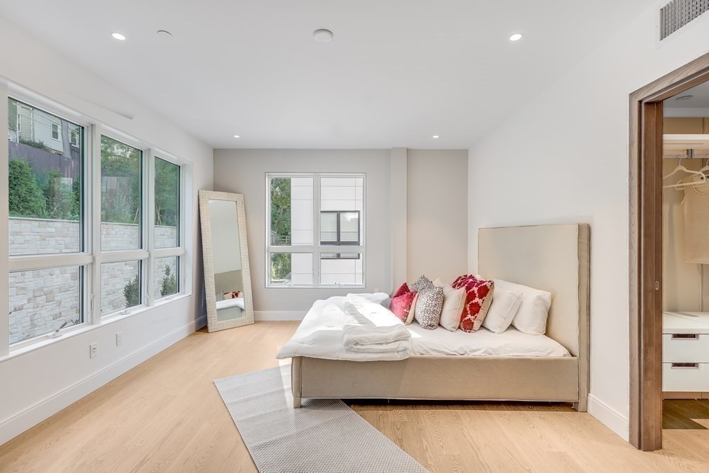 75 Westbourne Terrace, Unit 75 Brookline, MA 02446 - Photo 15 of 31 a spacious bedroom with a large bed and a couch