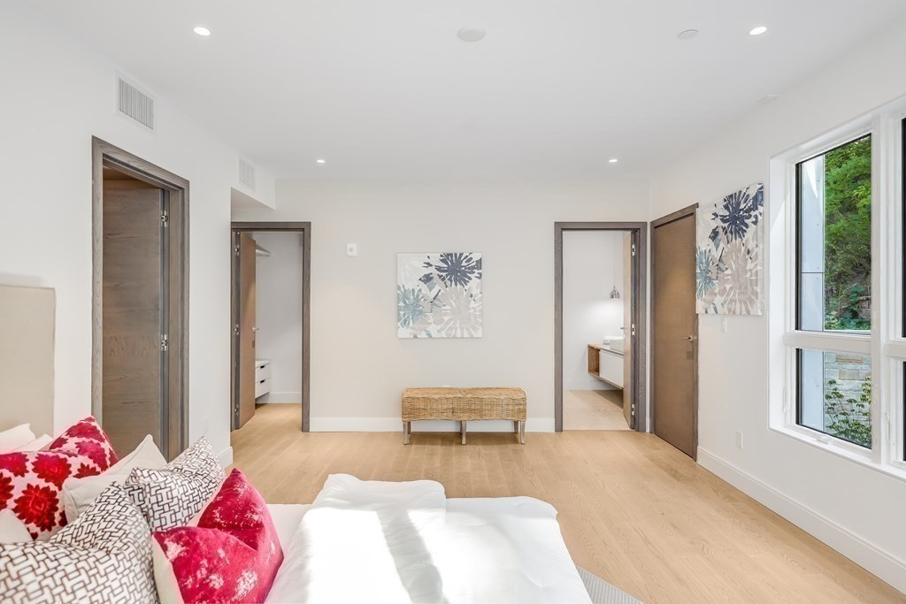 75 Westbourne Terrace, Unit 75 Brookline, MA 02446 - Photo 17 of 31 a bedroom with furniture and a large window