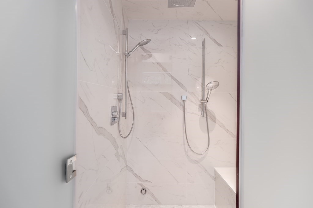 75 Westbourne Terrace, Unit 75 Brookline, MA 02446 - Photo 19 of 31 a bathroom with a glass shower door