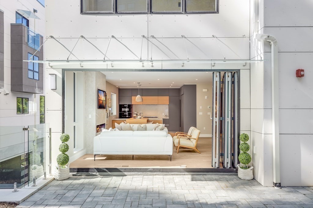 75 Westbourne Terrace, Unit 75 Brookline, MA 02446 - Photo 2 of 31 a view of a hallway with dining area and chandelier