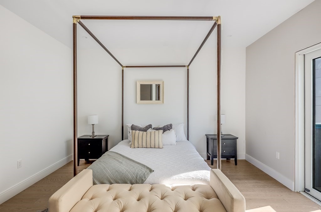 75 Westbourne Terrace, Unit 75 Brookline, MA 02446 - Photo 22 of 31 a bedroom with a bed and a table in it