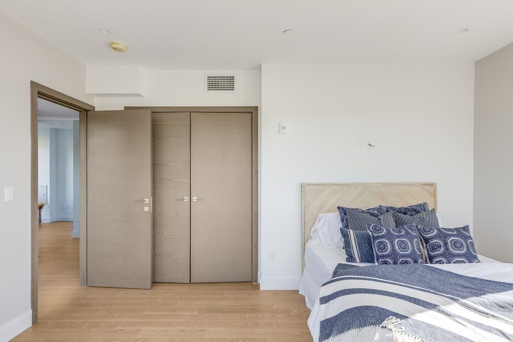 75 Westbourne Terrace, Unit 75 Brookline, MA 02446 - Photo 26 of 31 a view of a bedroom with bed and wooden floor