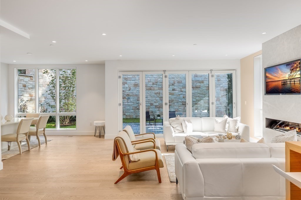 75 Westbourne Terrace, Unit 75 Brookline, MA 02446 - Photo 28 of 31 a living room with furniture and floor to ceiling windows