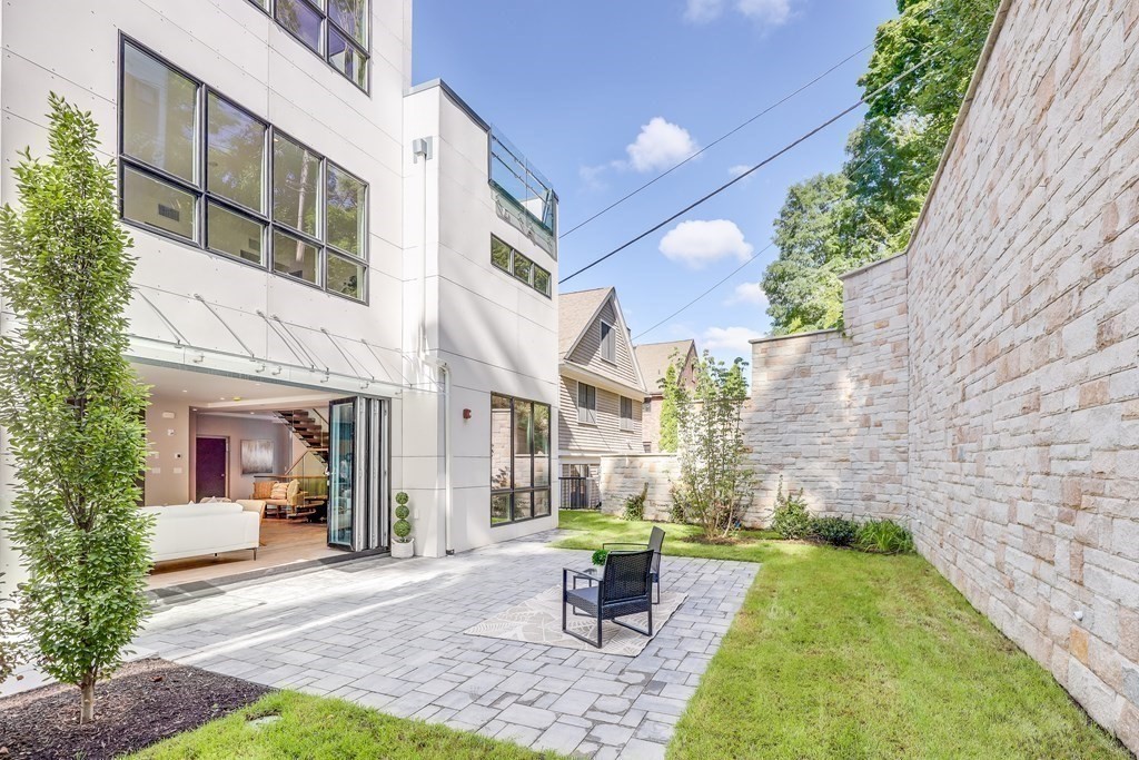 75 Westbourne Terrace, Unit 75 Brookline, MA 02446 - Photo 30 of 31 a view of a patio with couches table and chairs and potted plants