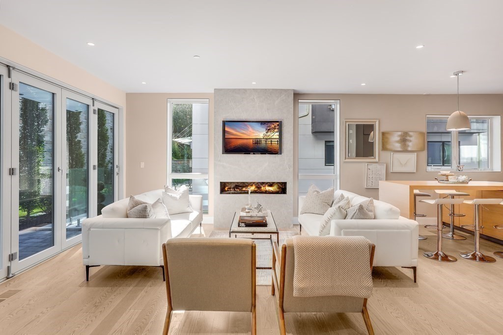 75 Westbourne Terrace, Unit 75 Brookline, MA 02446 - Photo 7 of 31 a living room with furniture and a flat screen tv