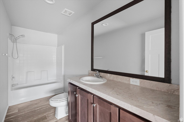 433 North 750 West Logan, UT 84321 - Photo 17 of 40 Full bathroom featuring a single vanity with wood cabinetry, a light-toned countertop, and a white integrated sink