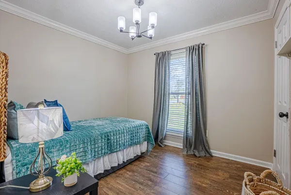a bedroom with a bed and a table