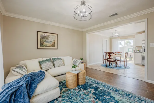 a living room with furniture and a dining table