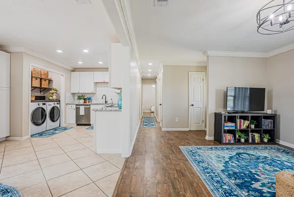 a view of a kitchen with fridge and workspace