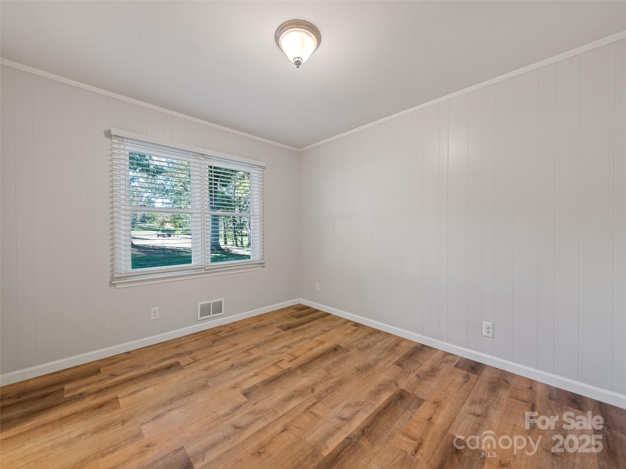 263 Blanton Street Columbus, NC 28722 - Photo 25 of 45 wooden floor in an empty room with a window