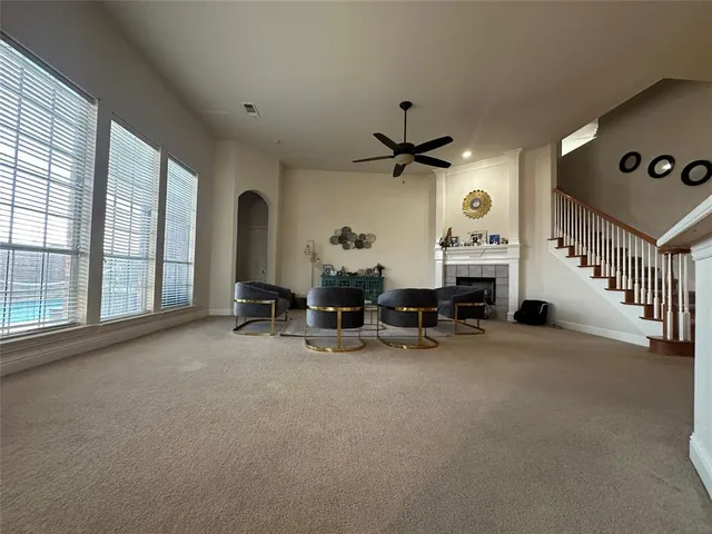 a view of a livingroom with furniture and a large window