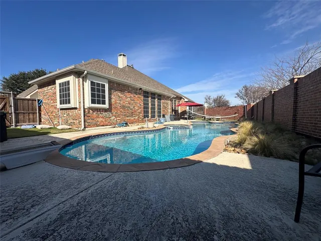 a view of a swimming pool with a patio