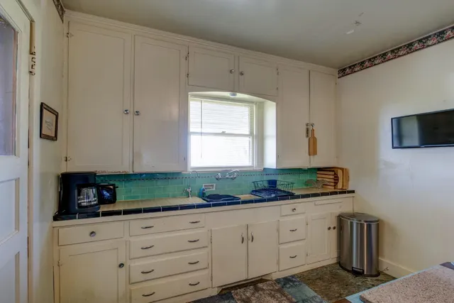 a en suite bathroom with a sink mirror and a shower