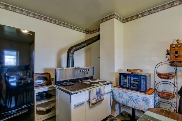 a view of a hallway with wooden floor and entryway