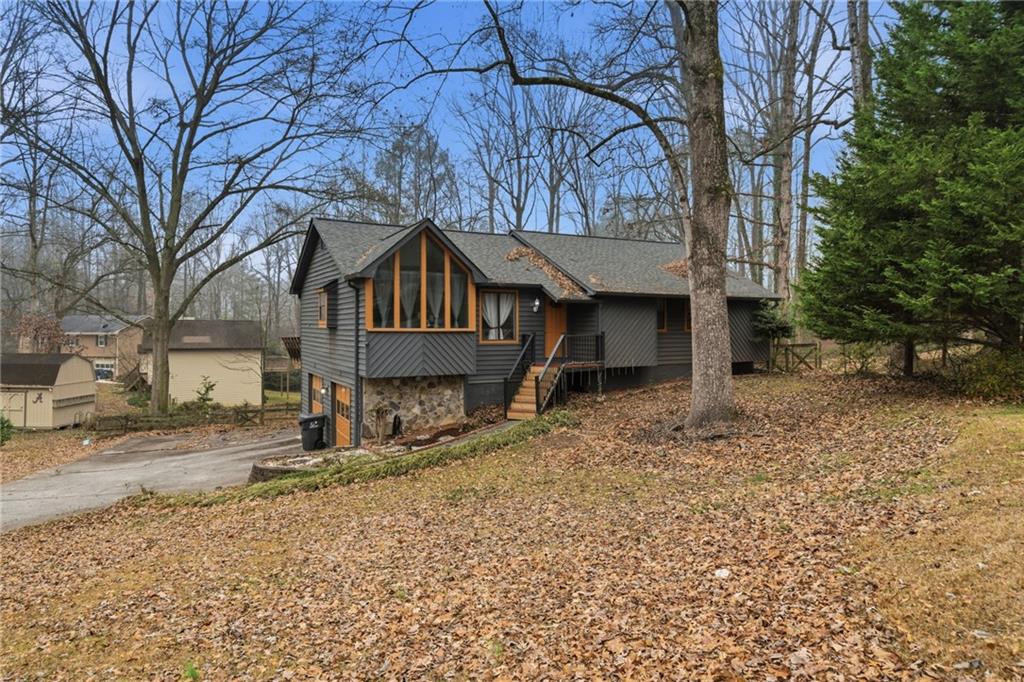 a front view of a house with a yard covered with snow