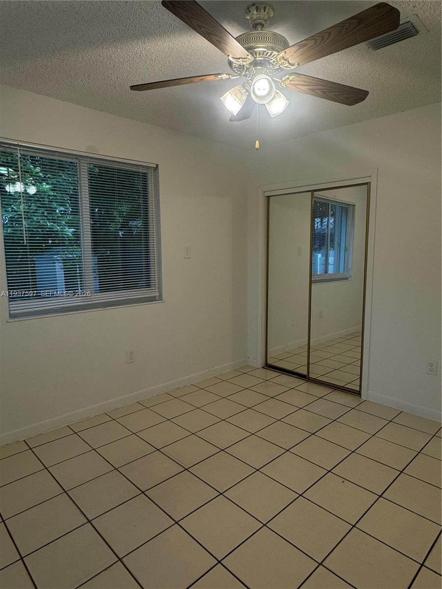 2311 Southwest 58th Avenue, Unit 2 Miami, FL 33155 - Photo 2 of 8 a view of an empty room with a window
