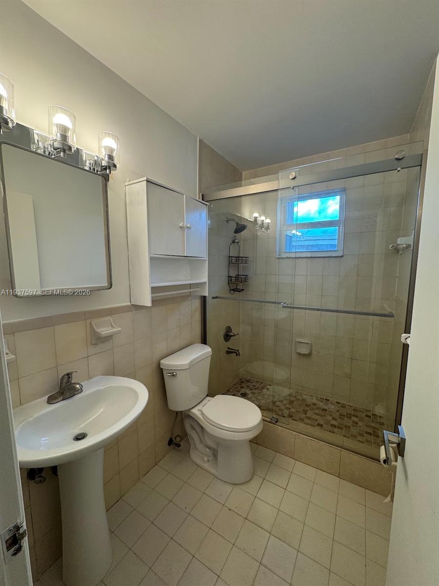 2311 Southwest 58th Avenue, Unit 2 Miami, FL 33155 - Photo 8 of 8 a bathroom with a sink a toilet and shower
