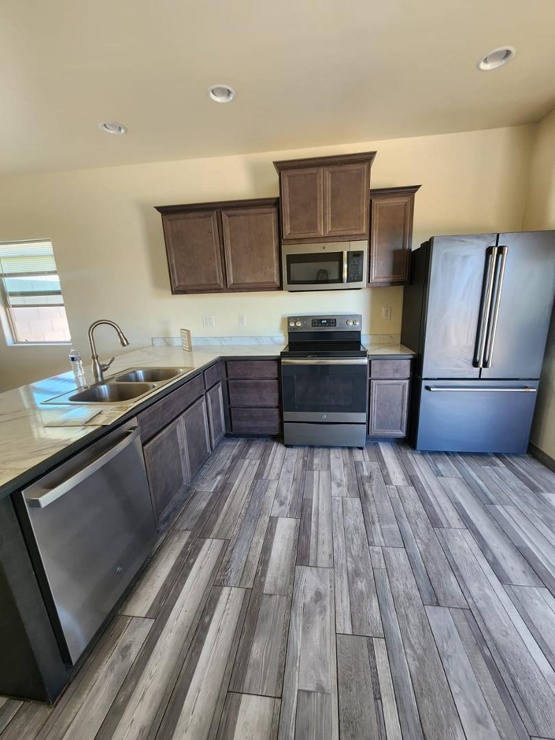 3641 Camino Del Rancho Douglas, AZ 85607 - Photo 3 of 20 a kitchen with stainless steel appliances granite countertop a sink dishwasher stove and oven