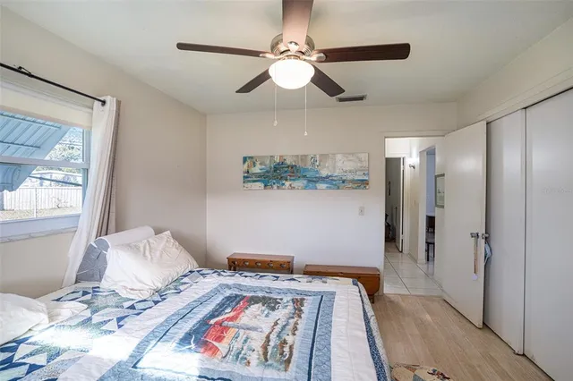 a bedroom with bed and a window