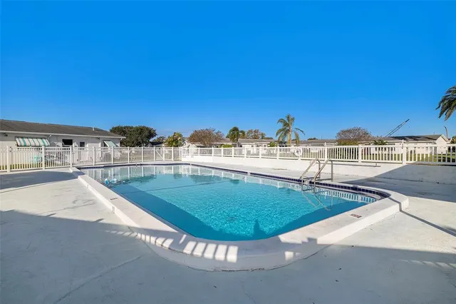 a view of a swimming pool with an outdoor seating