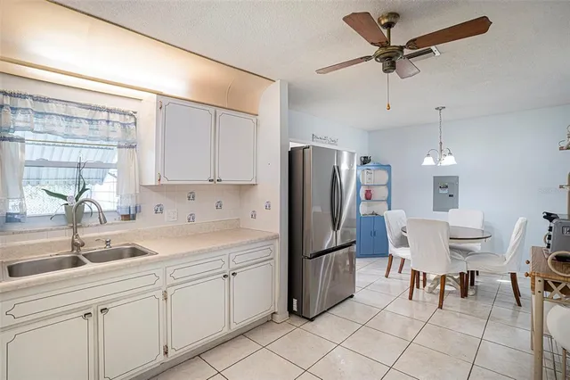 a kitchen with a refrigerator a sink and cabinets