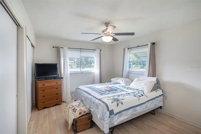 a bedroom with a bed and a tv