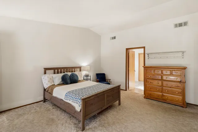 a bedroom with a bed and a dresser