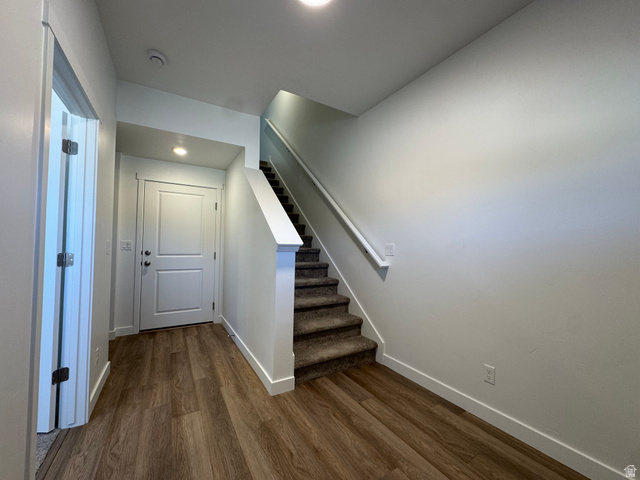 1476 North 1875 West, Unit 152 Layton, UT 84041 - Photo 2 of 20 Entryway featuring wood-finish flooring, a two-panel door with hardware, recessed lighting, and a carpeted staircase with a white handrail